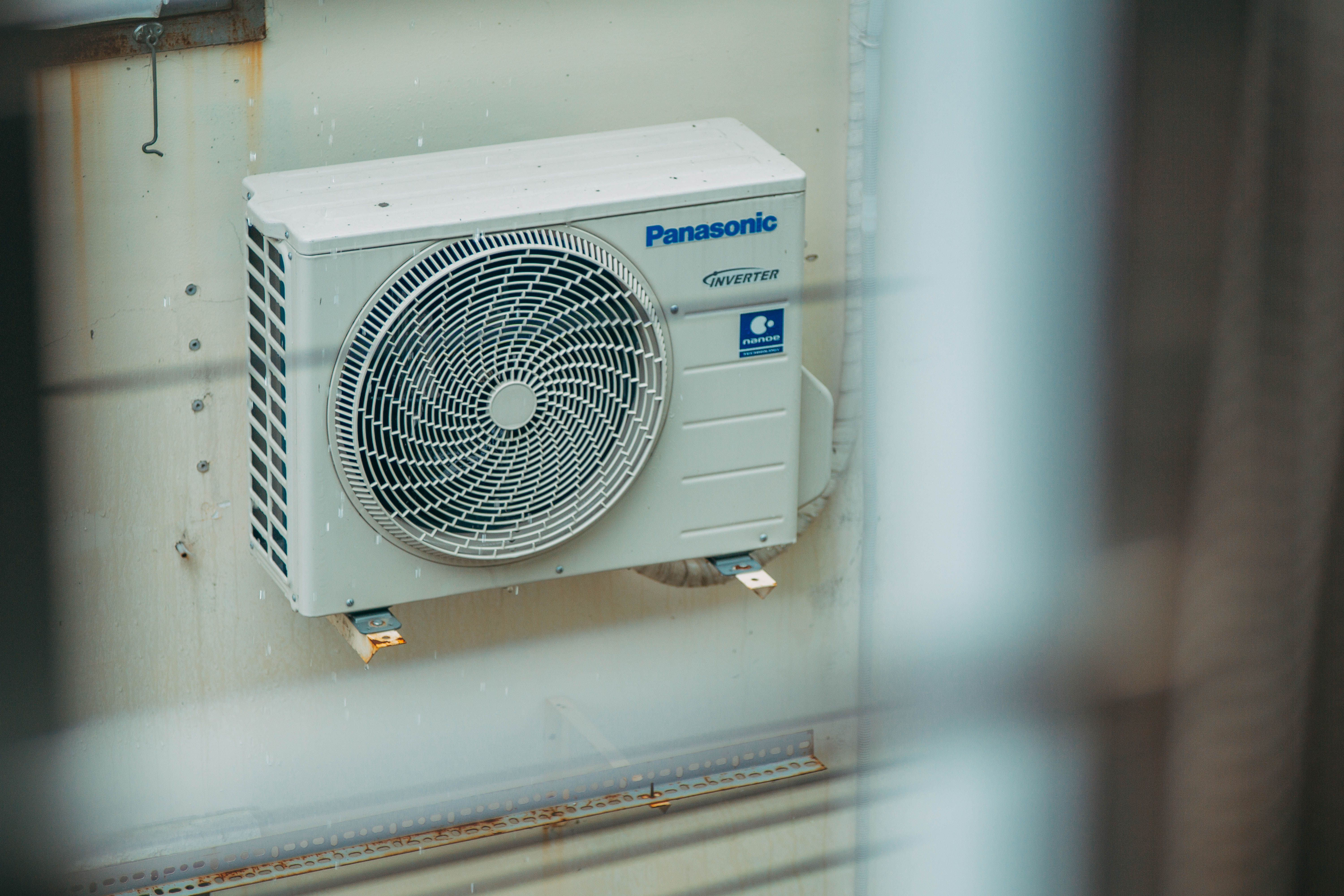 Technician evaluating HVAC repair or replacement options for an outdoor unit at a Tyler home in October.